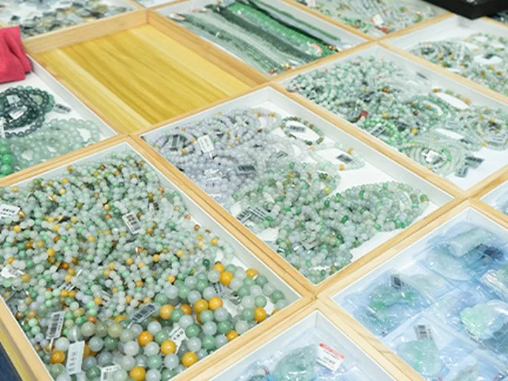 Jadeite beads graded into trays by colour